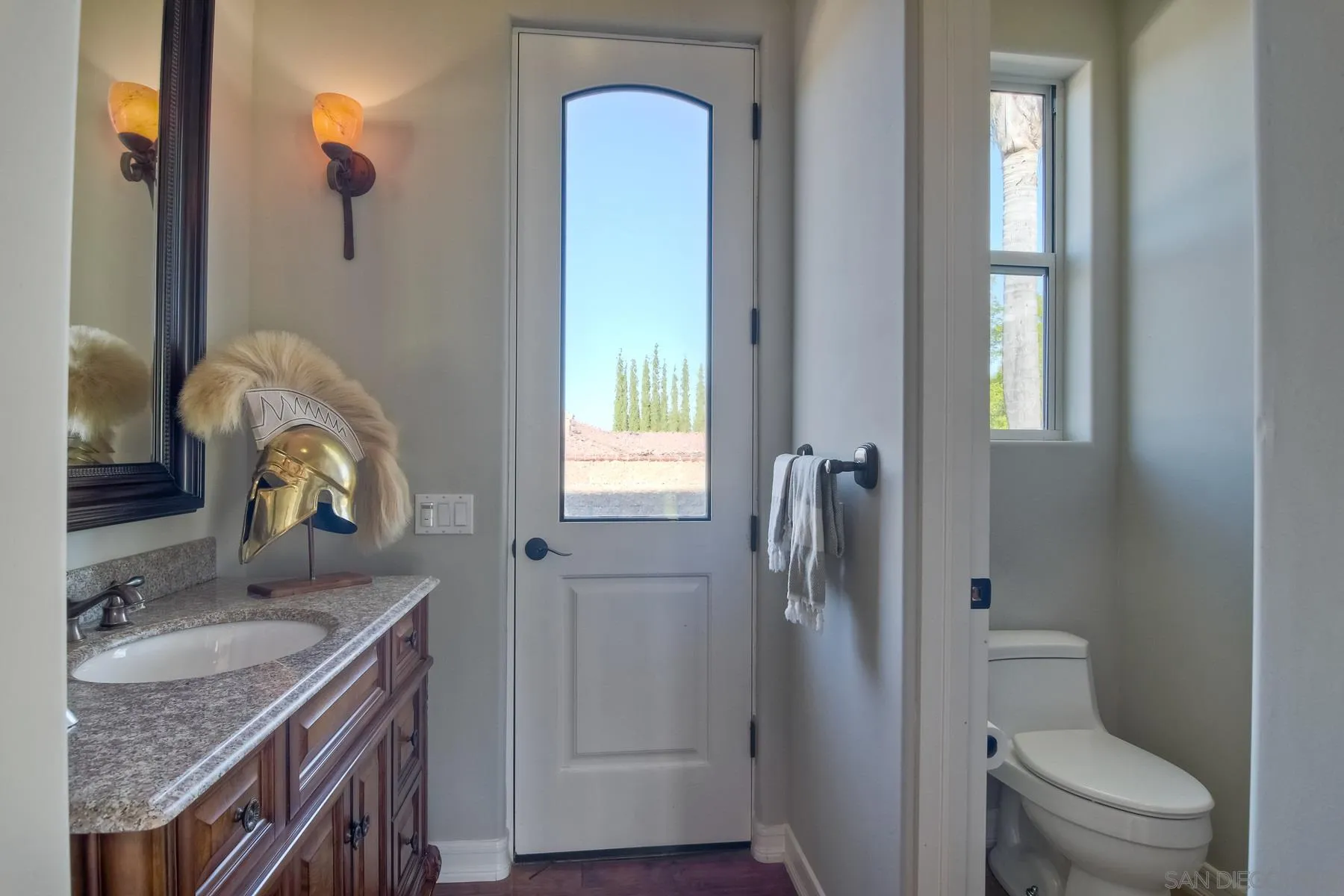 11739 Treadwell Drive Poway, CA 92064 - Photo 16 of 46 a bathroom with a granite countertop sink toilet and shower curtains