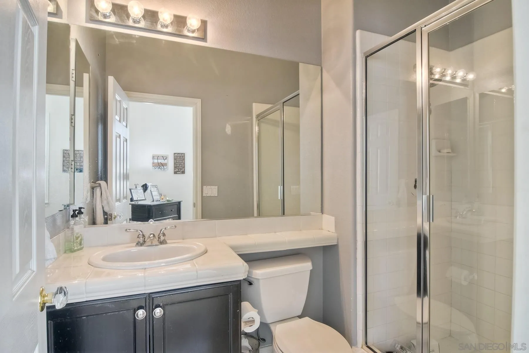 11739 Treadwell Drive Poway, CA 92064 - Photo 18 of 46 a bathroom with a sink toilet and shower