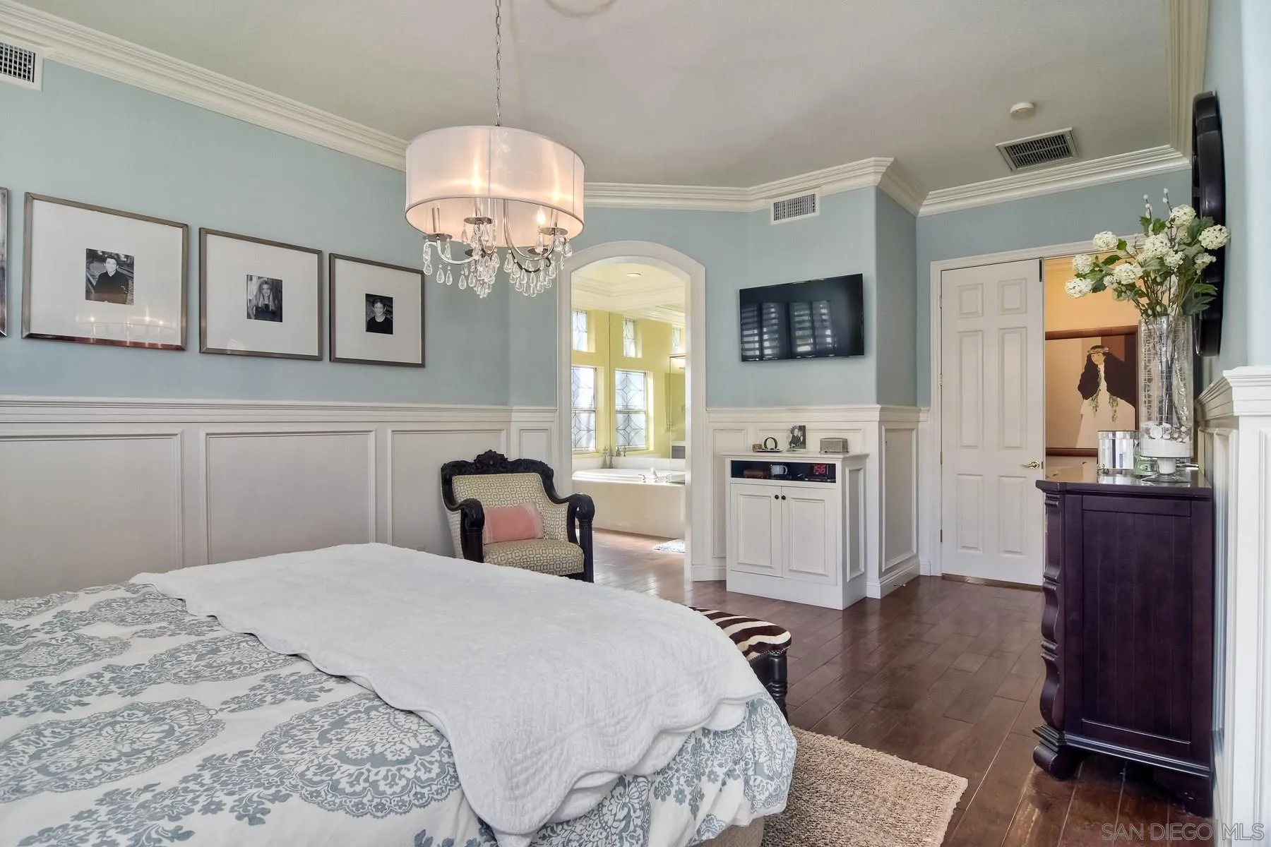 11739 Treadwell Drive Poway, CA 92064 - Photo 21 of 46 a bedroom with a bed and a chandelier