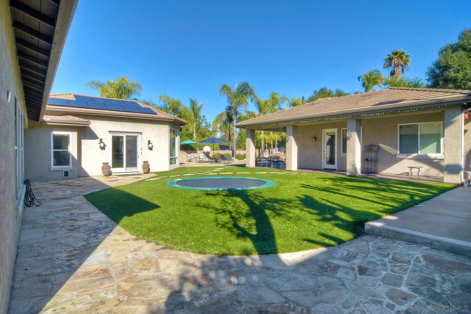 11739 Treadwell Drive Poway, CA 92064 - Photo 33 of 46 a view of a white house with a big yard potted plants and a large tree