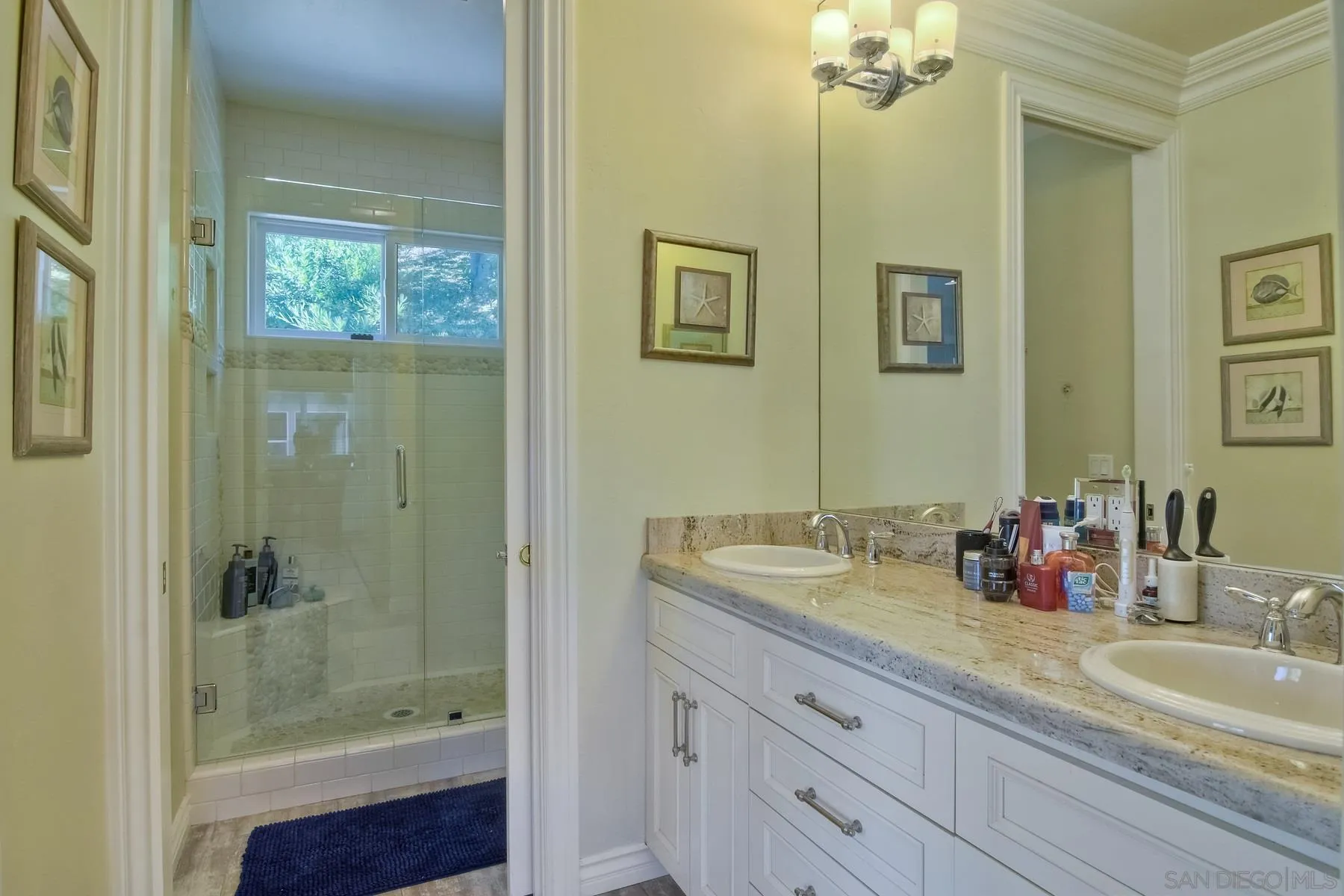 11739 Treadwell Drive Poway, CA 92064 - Photo 37 of 46 a bathroom with a shower sink and mirror