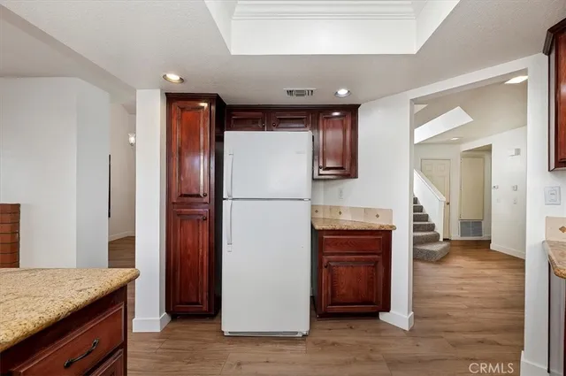 a kitchen with stainless steel appliances granite countertop a refrigerator and a stove