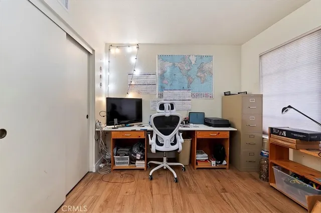 a view of a workspace with furniture and a window