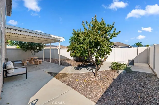 a view of a backyard with sitting area