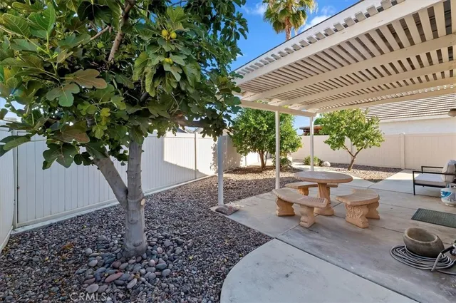 a view of a patio with table and chairs and potted plants