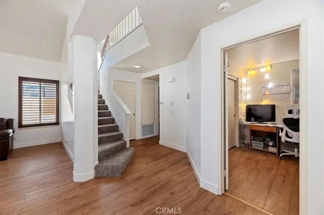 a view of a livingroom with wooden floor and furniture