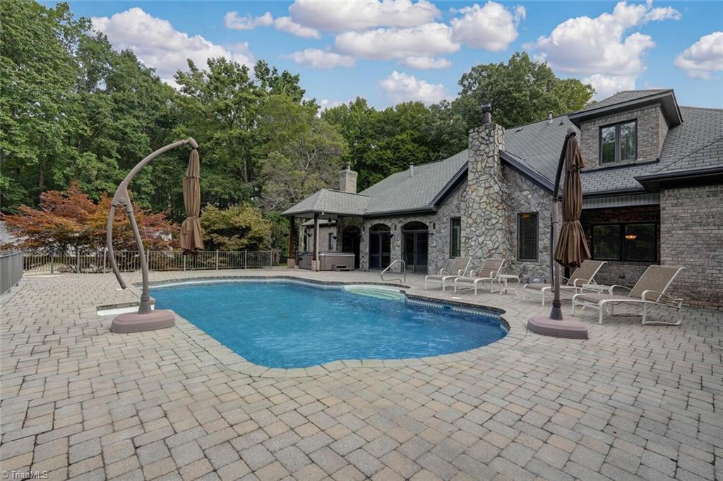 7809 Gold Ridge Road Oak Ridge, NC 27310 - Photo 40 of 50 GENEROUS POOL DECK AND HOT TUB BEYOND COMPLETE THE OUTDOOR ENTERTAINING AREA