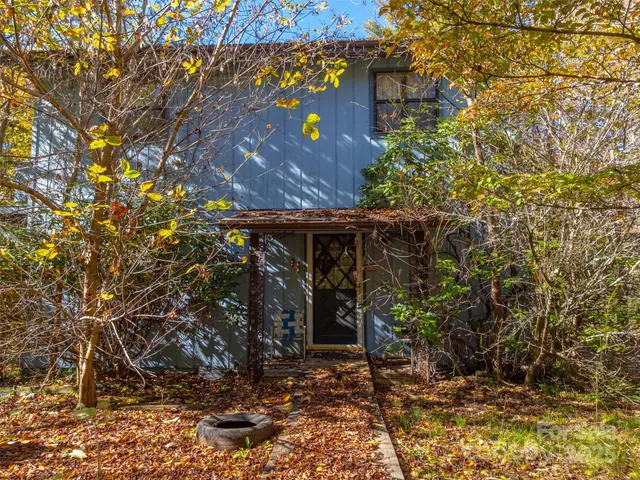 a view of a house with a tree