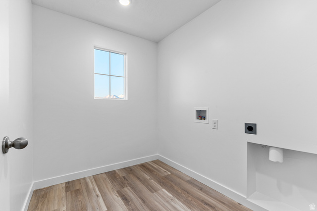 2829 North 710 West, Unit 15 Logan, UT 84321 - Photo 21 of 23 Laundry room featuring wood-finish flooring, a window with grid panes, a recessed ceiling light, and hookups for appliances