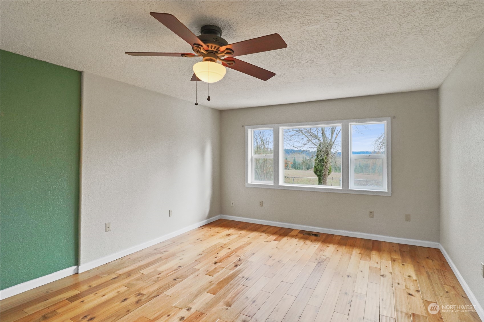 203 Stearns Road Chehalis, WA 98532 - Photo 8 of 34 a view of an empty room with wooden floor and a window