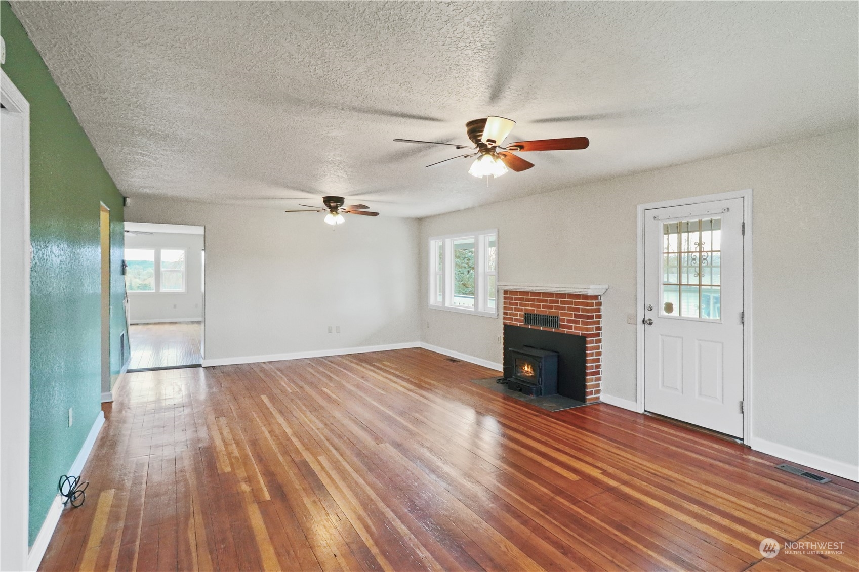 203 Stearns Road Chehalis, WA 98532 - Photo 10 of 34 wooden floor in an empty room with a fireplace