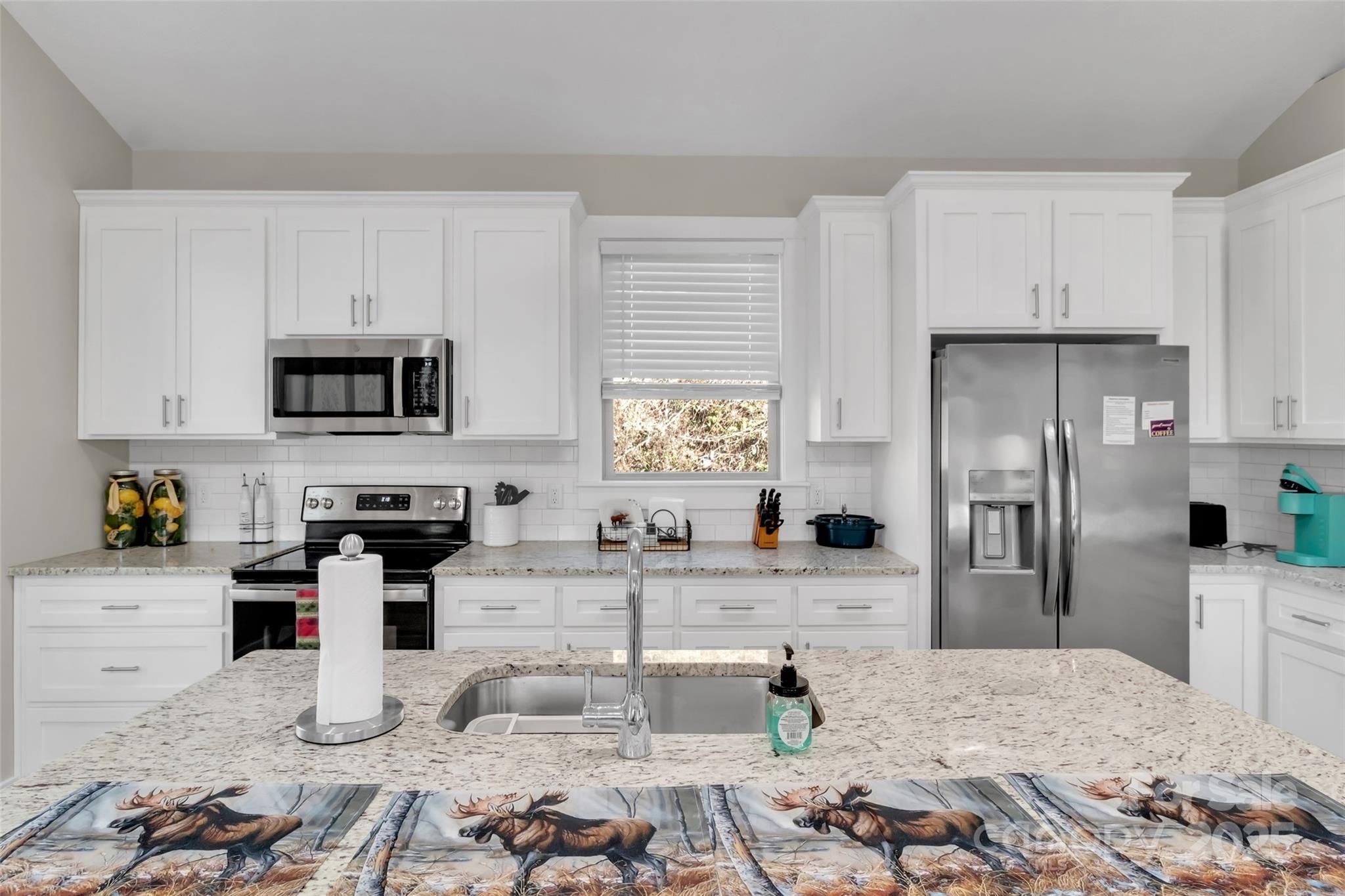 78 Rio Bravo Drive Sylva, NC 28779 - Photo 11 of 19 a kitchen with granite countertop a sink stove and refrigerator