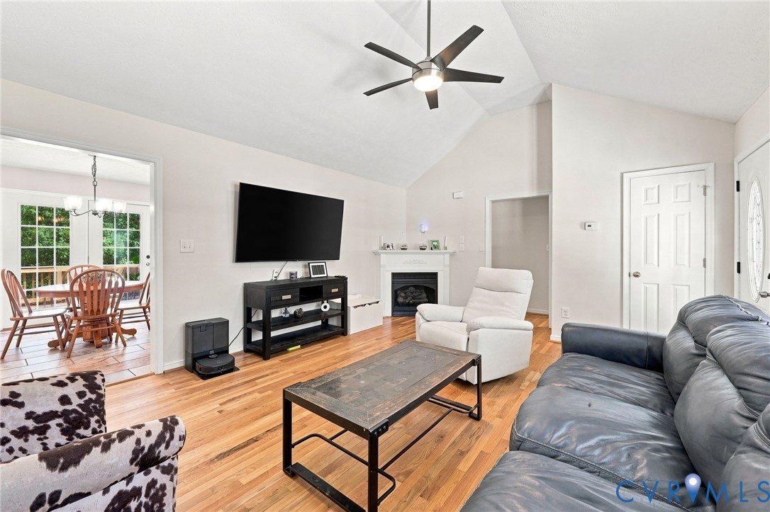 16753 Jolly Road Disputanta, VA 23842 - Photo 11 of 44 Vaulted ceiling with a ceiling fan, hardwood floor
