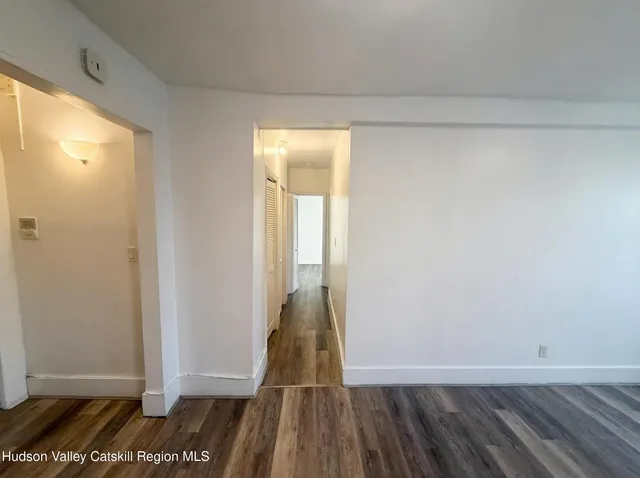 a view of a room with wooden floor and a window