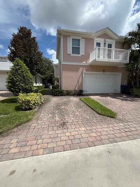 1382 Dakota Drive, Unit 2 Jupiter, FL 33458 - Photo 2 of 17 a front view of house with yard and trees around