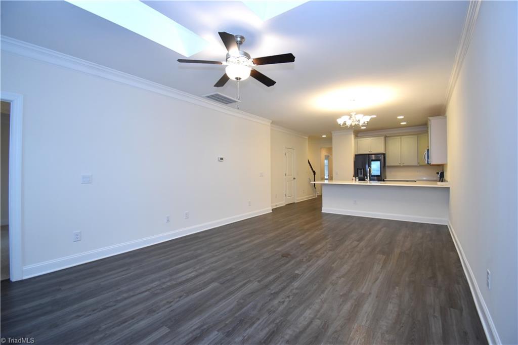 2270 Willard Dairy Road High Point, NC 27265 - Photo 13 of 28 Another view from the far corner of the house. Those sky lights let in a lot of light even though it was raining during our photo shoot. Lets go through the door on our left into the primary bedroom.