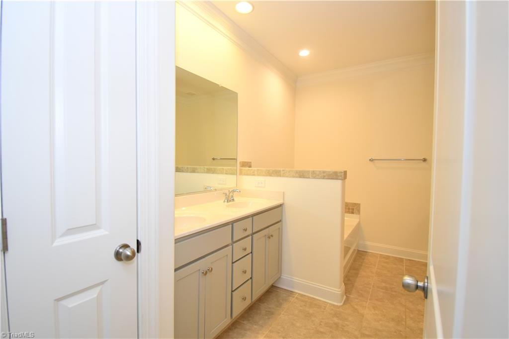 2270 Willard Dairy Road High Point, NC 27265 - Photo 16 of 28 The private primary en-suite. Towel storage on the left, double sink, and soaking tub on the left.