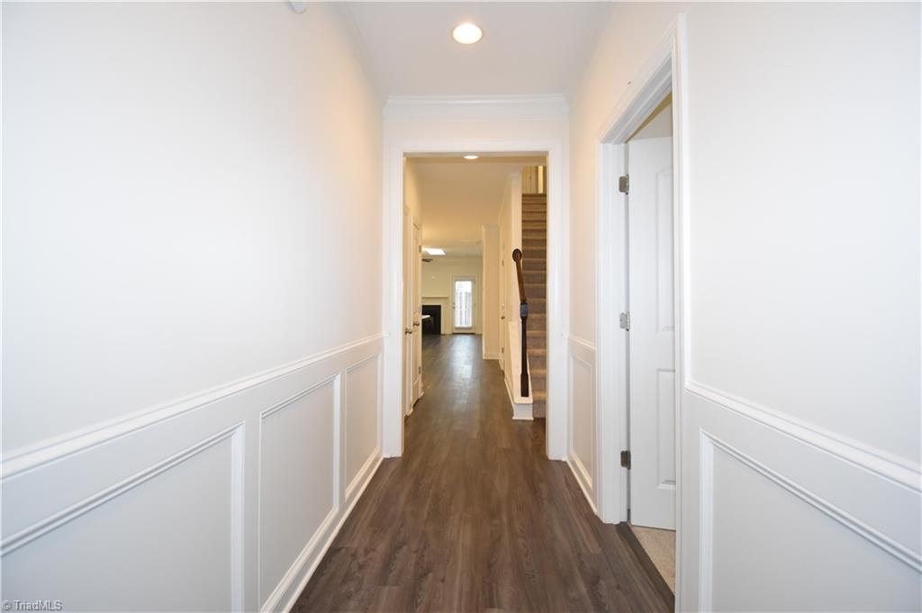 2270 Willard Dairy Road High Point, NC 27265 - Photo 2 of 28 Front entry hall with the first floor guest bedroom/office on the right and the door to the garage on the left.