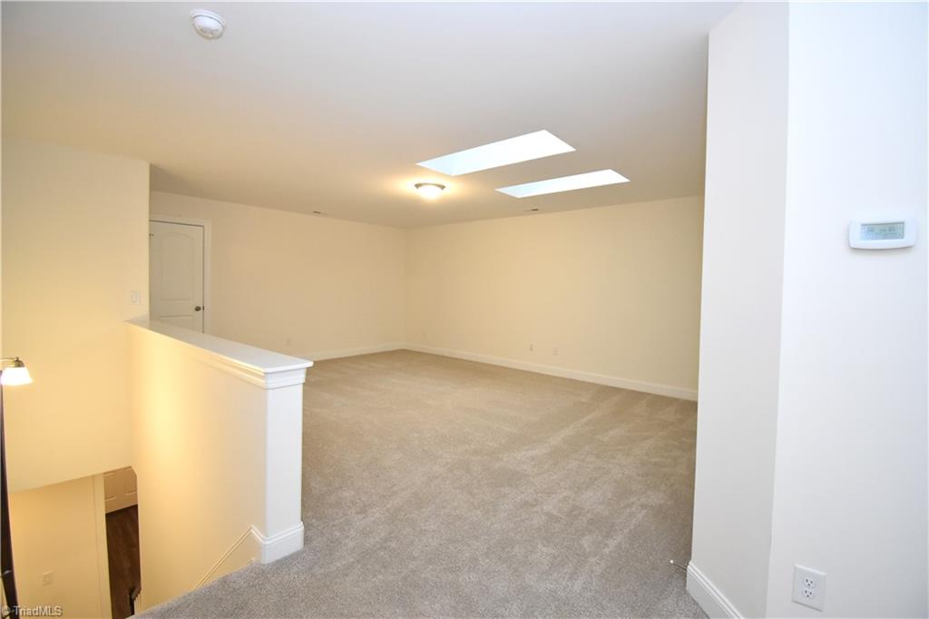 2270 Willard Dairy Road High Point, NC 27265 - Photo 21 of 28 Lets head upstairs to the oversized loft that features two skylights and additional attic storage access.