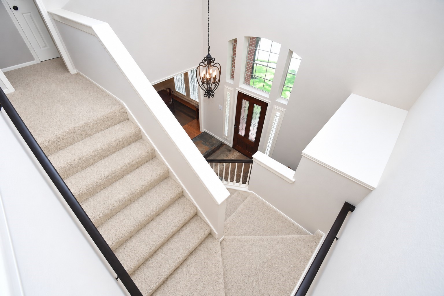 1703 Fall Ridge Circle Katy, TX 77494 - Photo 23 of 38 Stunning switchback staircase open to the grand foyer, featuring a large, beautiful window above the front door.