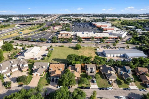 an aerial view of residential houses with outdoor space