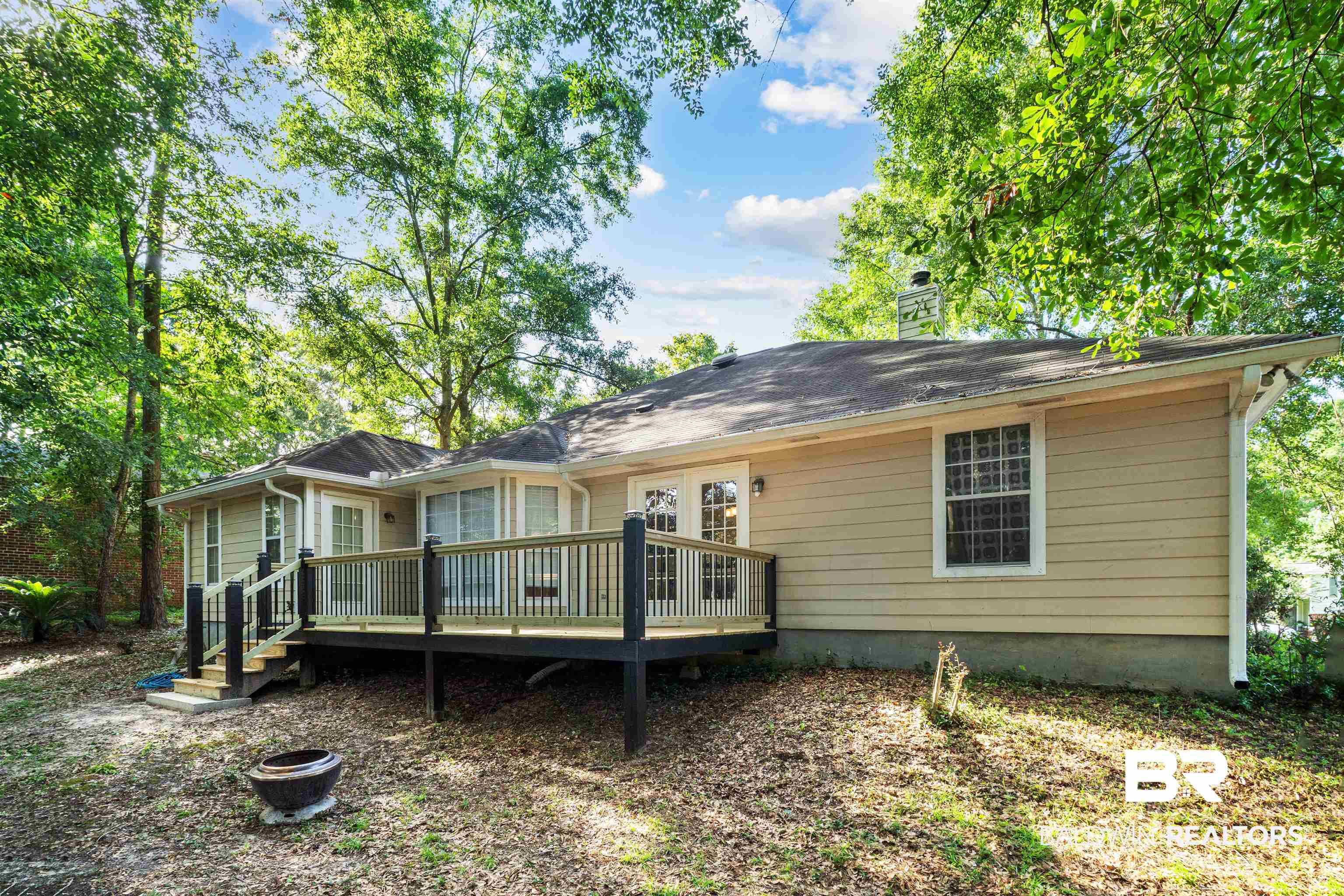153 Lakeview Loop Daphne, AL 36526 - Photo 47 of 56 Recently resurfaced, this expansive deck is ready for summer gatherings, weekend cookouts, and quiet evenings under the trees.