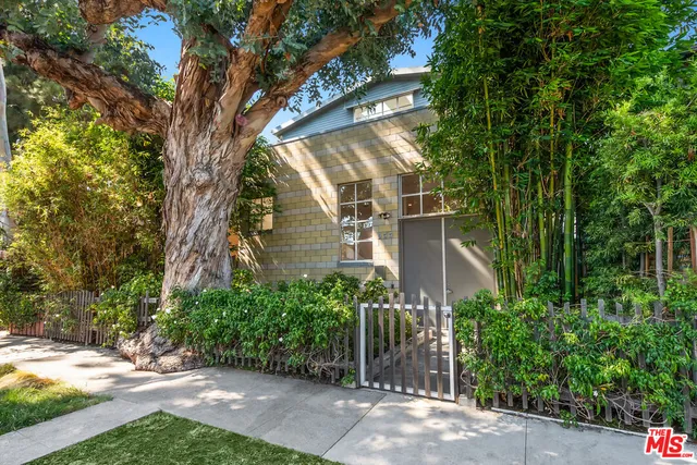 a view of a house with a tree in front