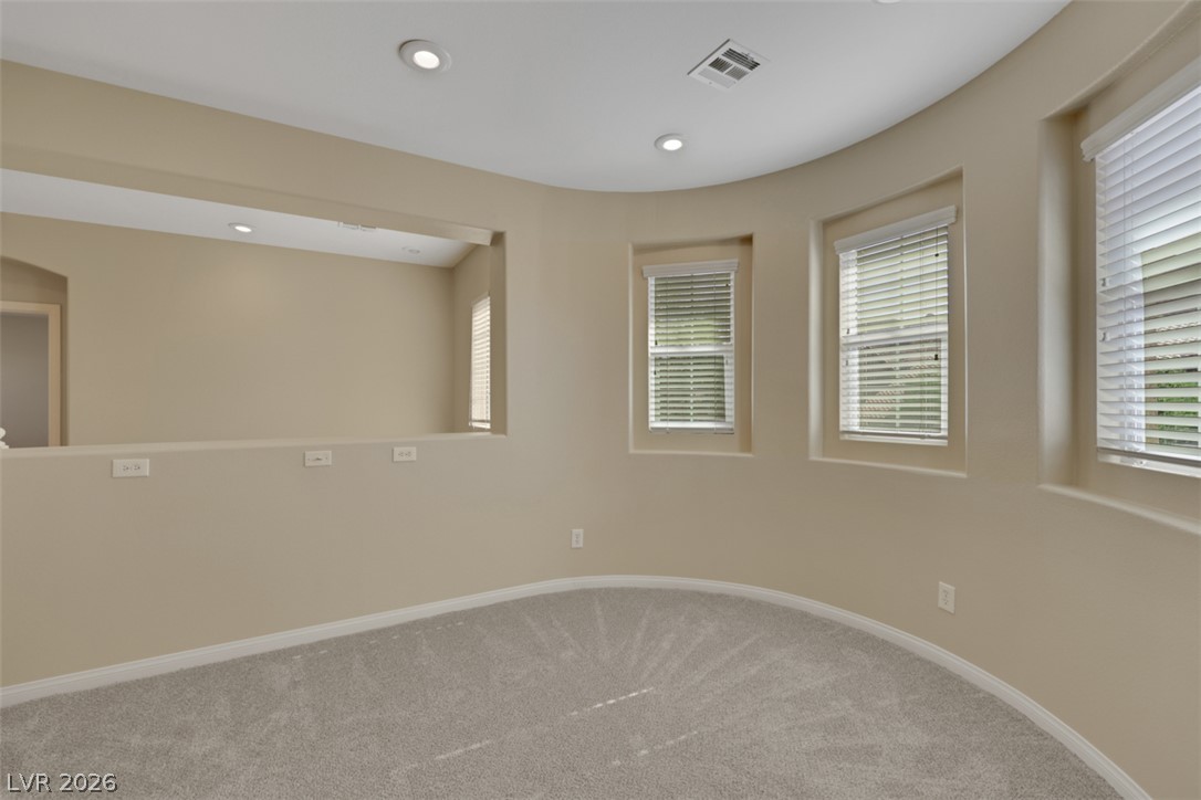 10328 Hawk Ravine Street Las Vegas, NV 89178 - Photo 25 of 55 A quiet loft space offers a curved wall of windows and an interior balcony overlooking the floor below.