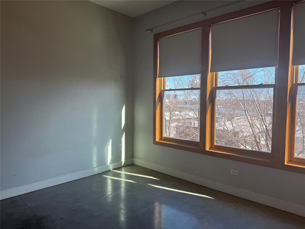2502 Live Oak Street, Unit 228 Dallas, TX 75204 - Photo 11 of 21 an empty room with wooden floor and windows
