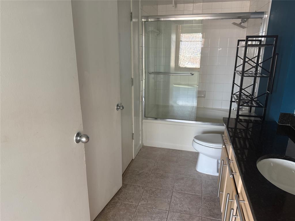 2502 Live Oak Street, Unit 228 Dallas, TX 75204 - Photo 13 of 21 a bathroom with a shower a toilet and a sink