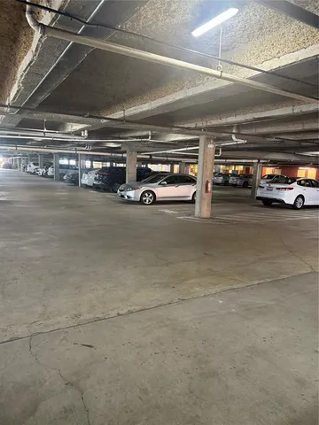 a view of parking garage with cars