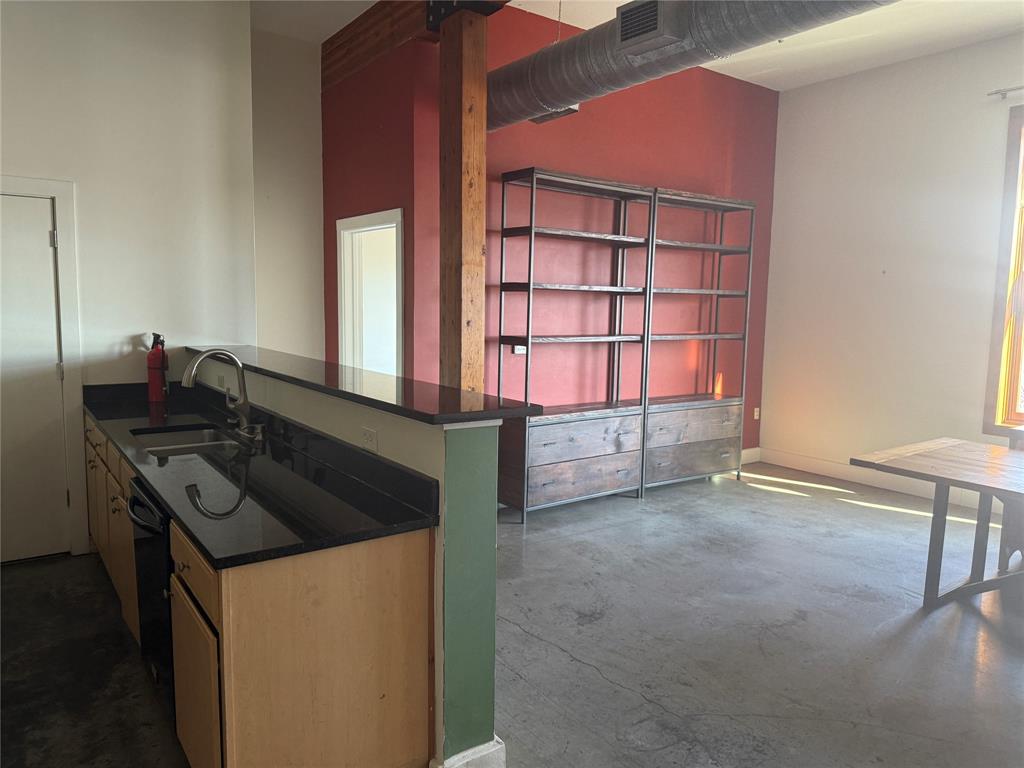 2502 Live Oak Street, Unit 228 Dallas, TX 75204 - Photo 6 of 21 a kitchen with granite countertop a stove and a cabinet