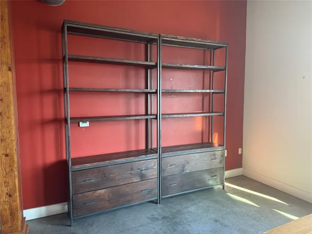 a room with walk in closet and empty racks