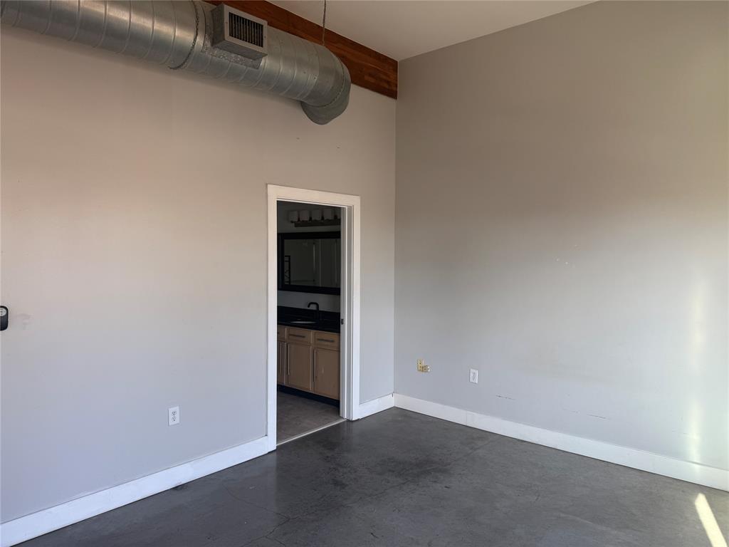 2502 Live Oak Street, Unit 228 Dallas, TX 75204 - Photo 9 of 21 an empty room with a kitchen