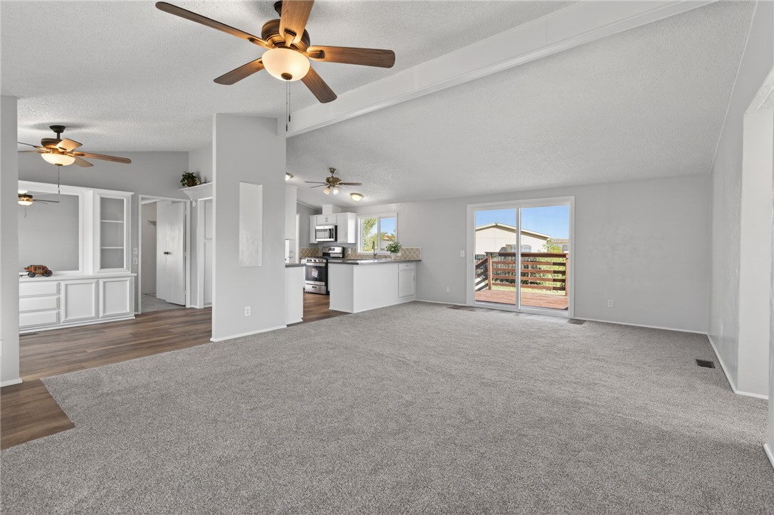 2294 South Dragoon Road Golden Valley, AZ 86413 - Photo 20 of 35 Unfurnished living room with carpet and baseboards