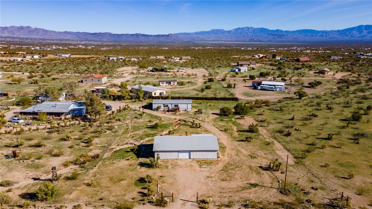 2294 South Dragoon Road Golden Valley, AZ 86413 - Photo 3 of 35 Aerial view of sparsely populated area featuring a mountainous background and a desert landscape