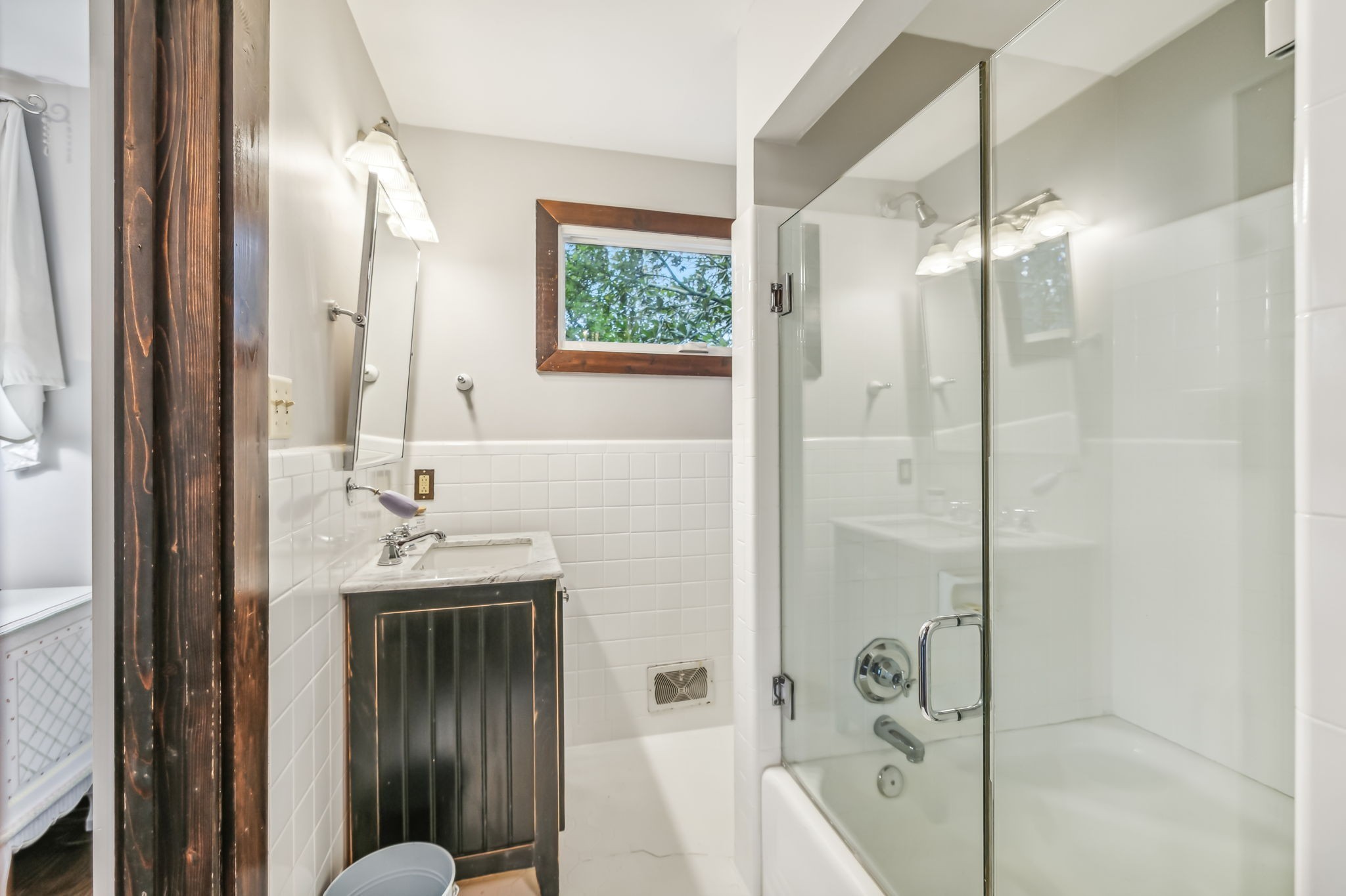2864 Sawyer Bend Road Nashville, TN 37221 - Photo 47 of 94 a bathroom with a sink a mirror a glass door a shower and vanity