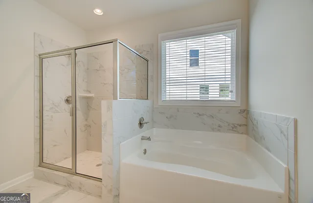 a bathroom with a bathtub and a shower