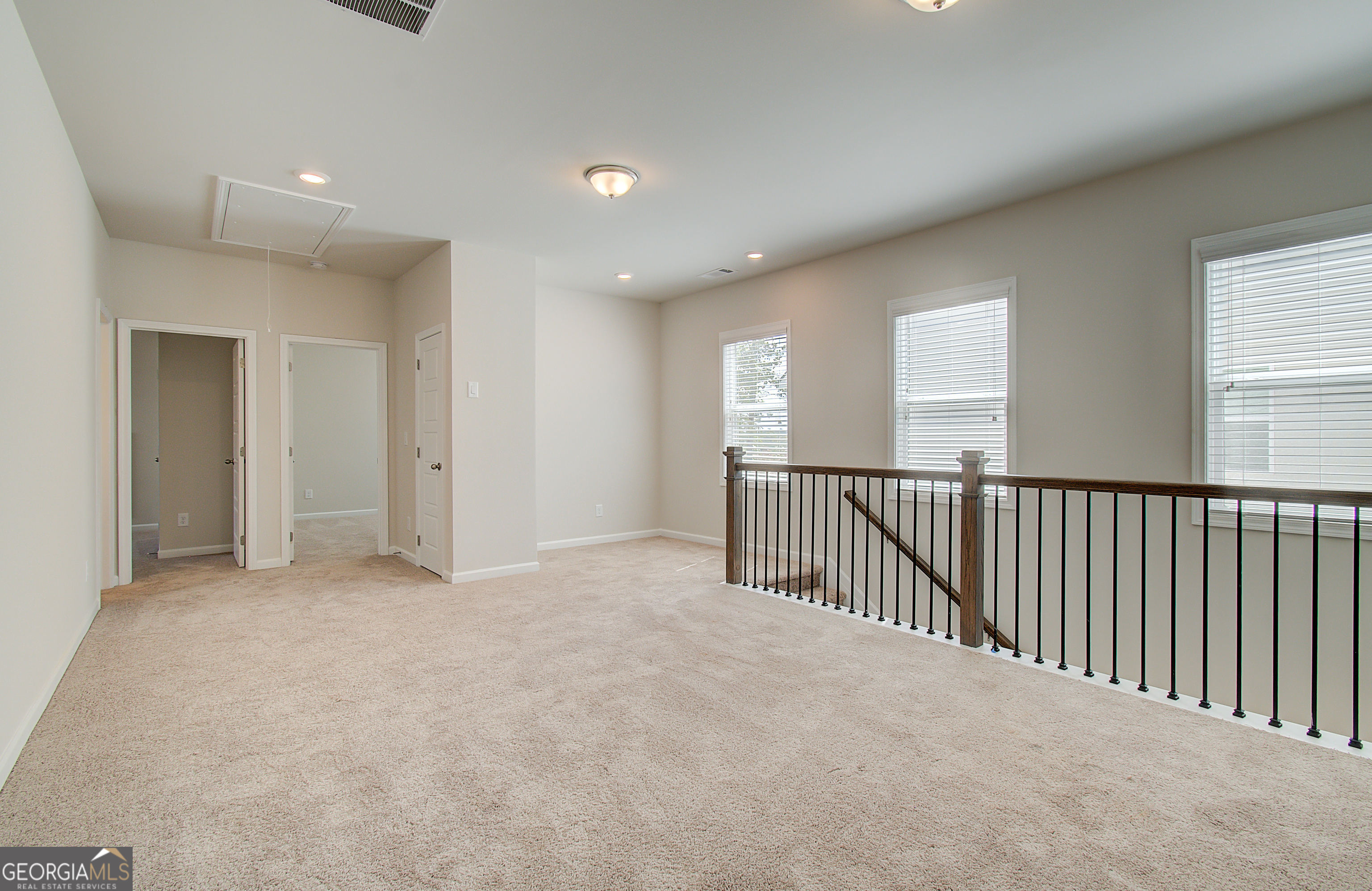 71 Avian Way, Unit 17B Auburn, GA 30011 - Photo 14 of 32 a view of an empty room with windows
