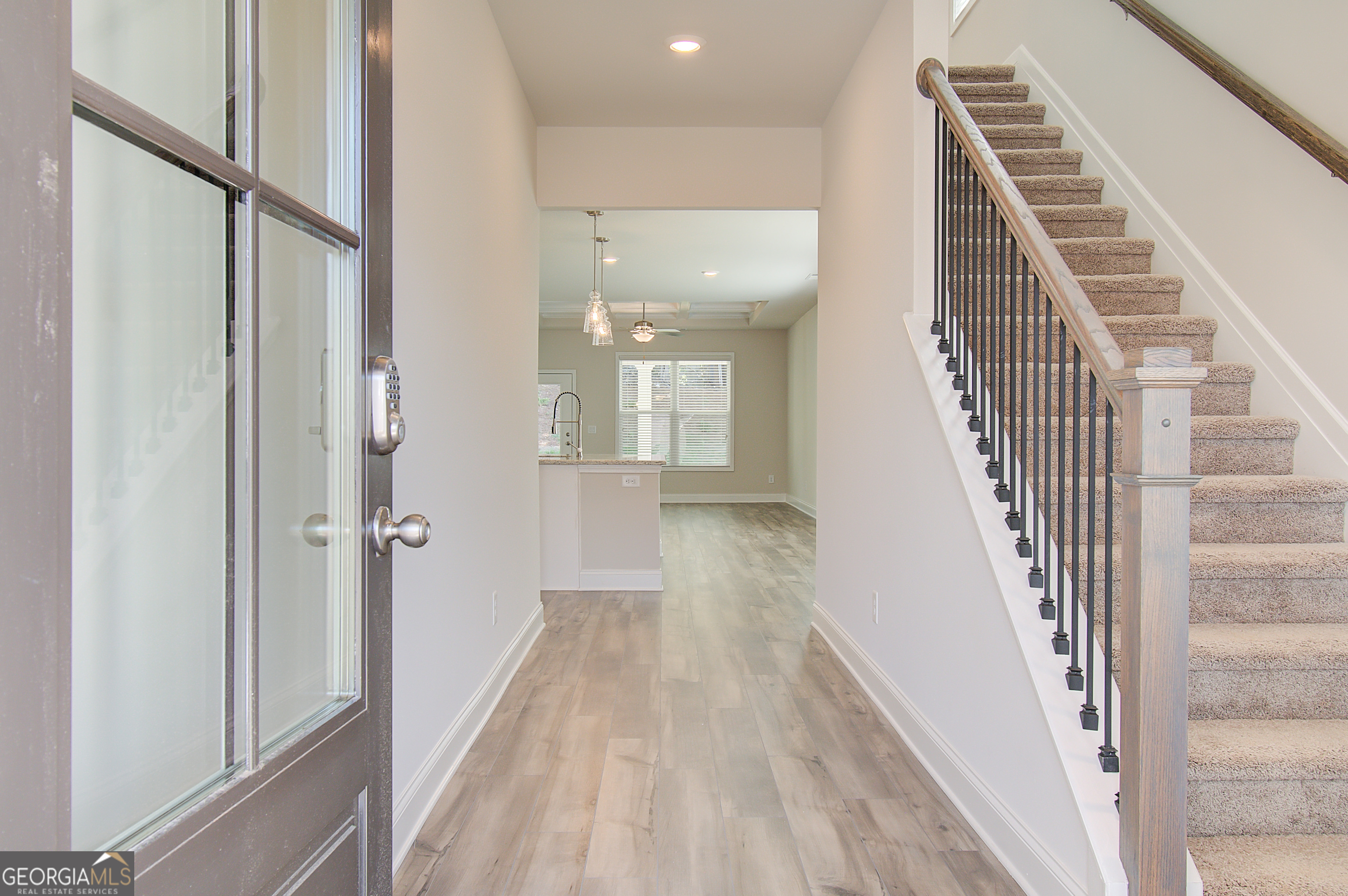 71 Avian Way, Unit 17B Auburn, GA 30011 - Photo 3 of 32 a view of a hallway with wooden floor and entryway