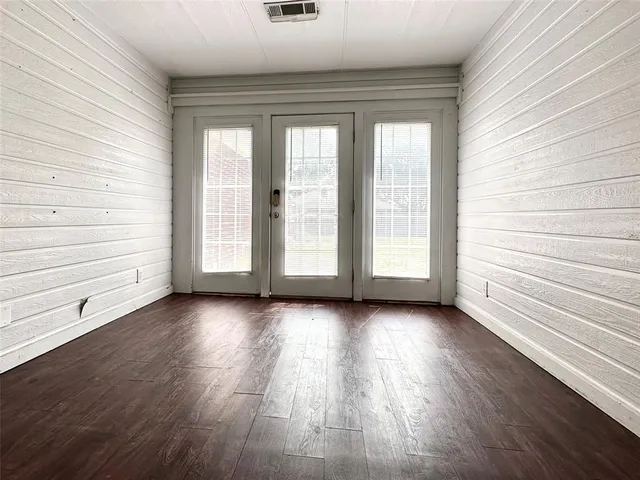 a view of a room with wooden floor and window