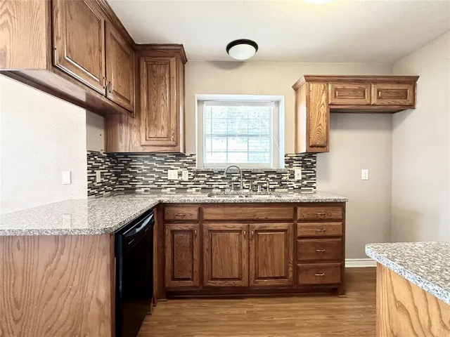 a kitchen with stainless steel appliances granite countertop a sink stove and cabinets