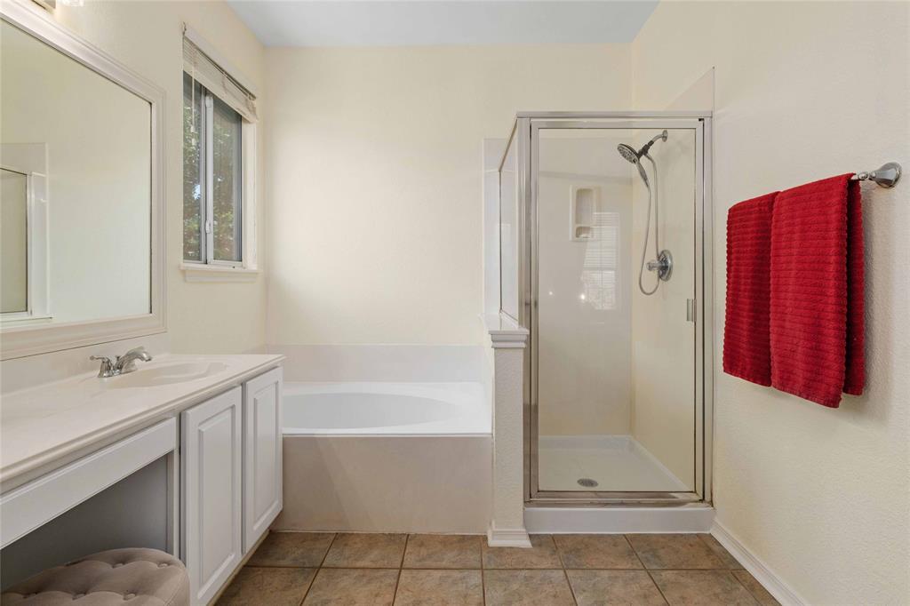 2730 Kinney Oaks Court Austin, TX 78704 - Photo 19 of 32 A glass-enclosed shower alongside a deep soaking tub provides a relaxing master bath retreat.