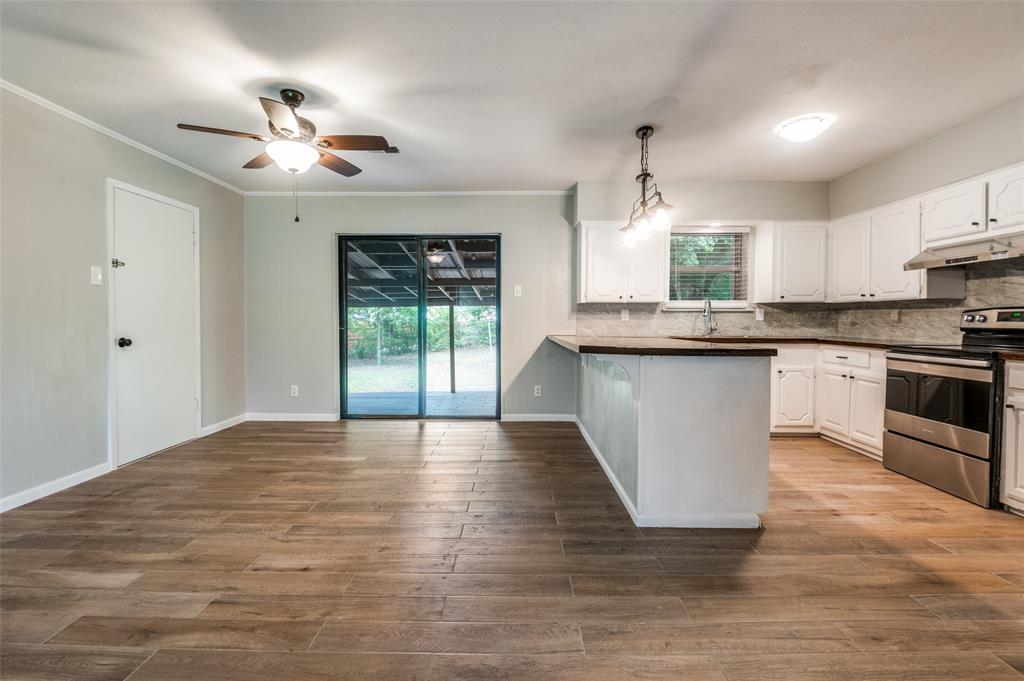 1533 East Springcrest Circle Lancaster, TX 75134 - Photo 13 of 25 Spacious interior featuring wood-finish flooring, light grey walls, and white trim