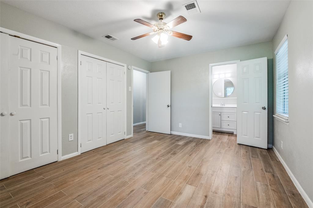 1533 East Springcrest Circle Lancaster, TX 75134 - Photo 20 of 25 Room featuring wood-finish flooring, light gray walls, and a ceiling fan with integrated lighting