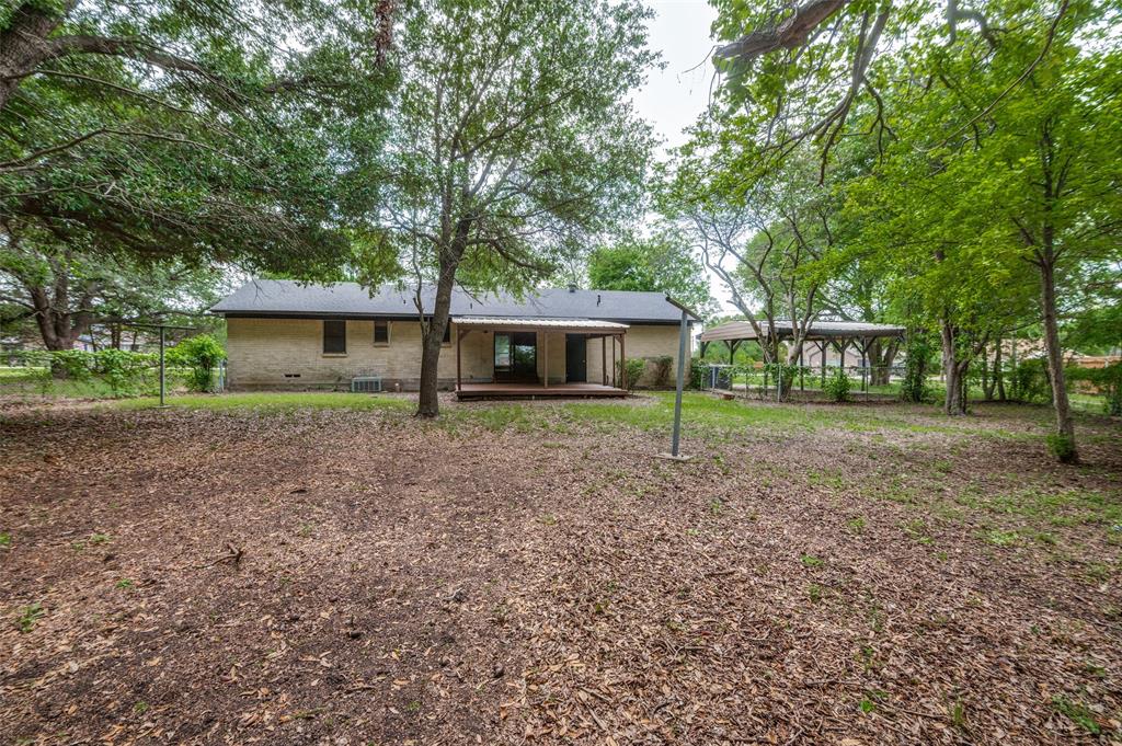 1533 East Springcrest Circle Lancaster, TX 75134 - Photo 25 of 25 Extensive backyard featuring a mature tree canopy, a covered patio, and a separate gazebo structure