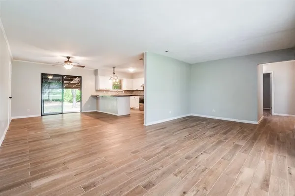 a view of a kitchen with wooden floor and a window
