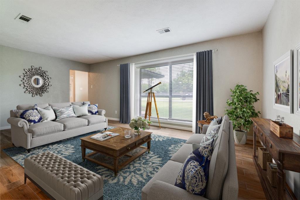1533 East Springcrest Circle Lancaster, TX 75134 - Photo 6 of 25 Spacious living area featuring wood-finish flooring, light-toned wall paint, and a large window with blinds