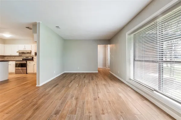 wooden floor in an empty room with a window