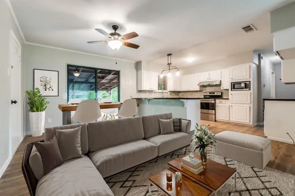 a living room with furniture and kitchen view